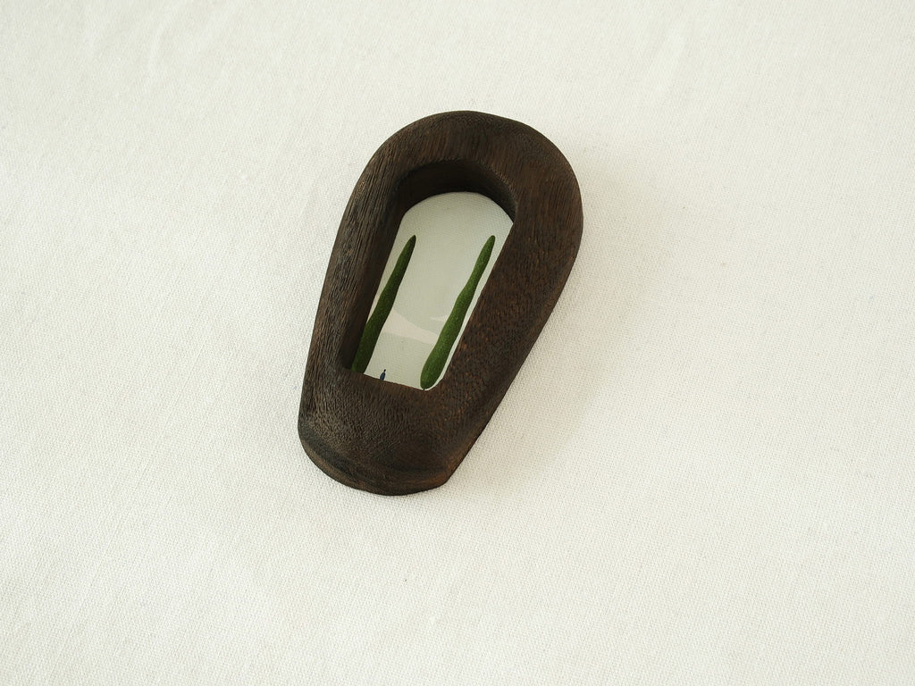 Angled side view of the black arched wood frame, revealing its smooth curved profile and elegant dark wood grain.