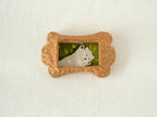 Front view of the bone-shaped wood pet frame, highlighting its symmetrical organic silhouette and detailed hand-chiselled surface.