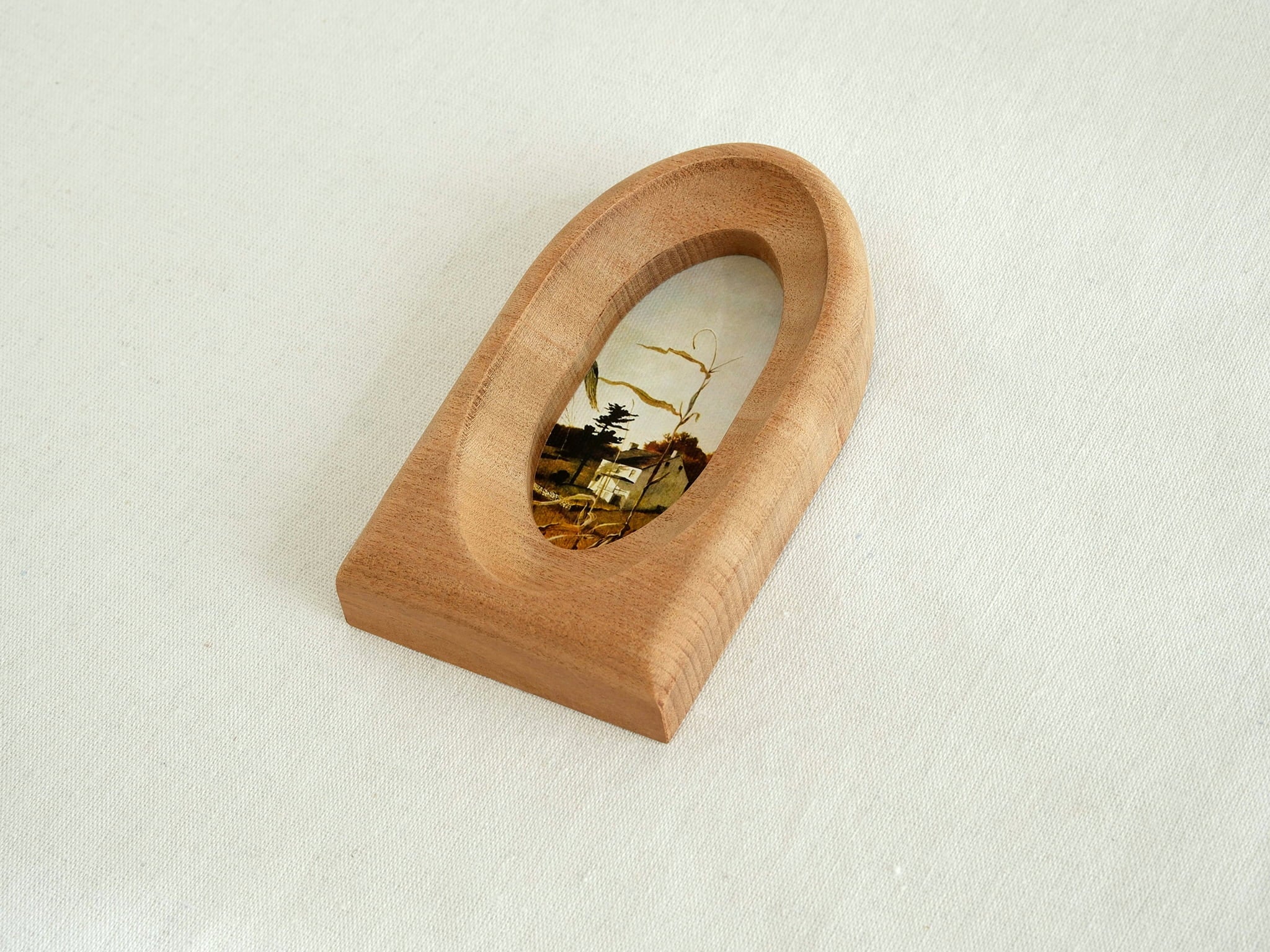 Alternative side view of the arched wood frame, emphasizing its smooth curved top and solid architectural base.