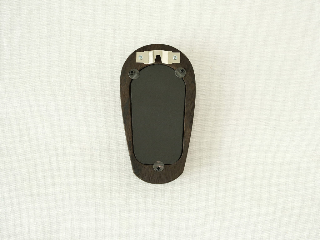 Back view of the black arched frame, featuring an integrated metal wall hanger and three secure swivel tabs.