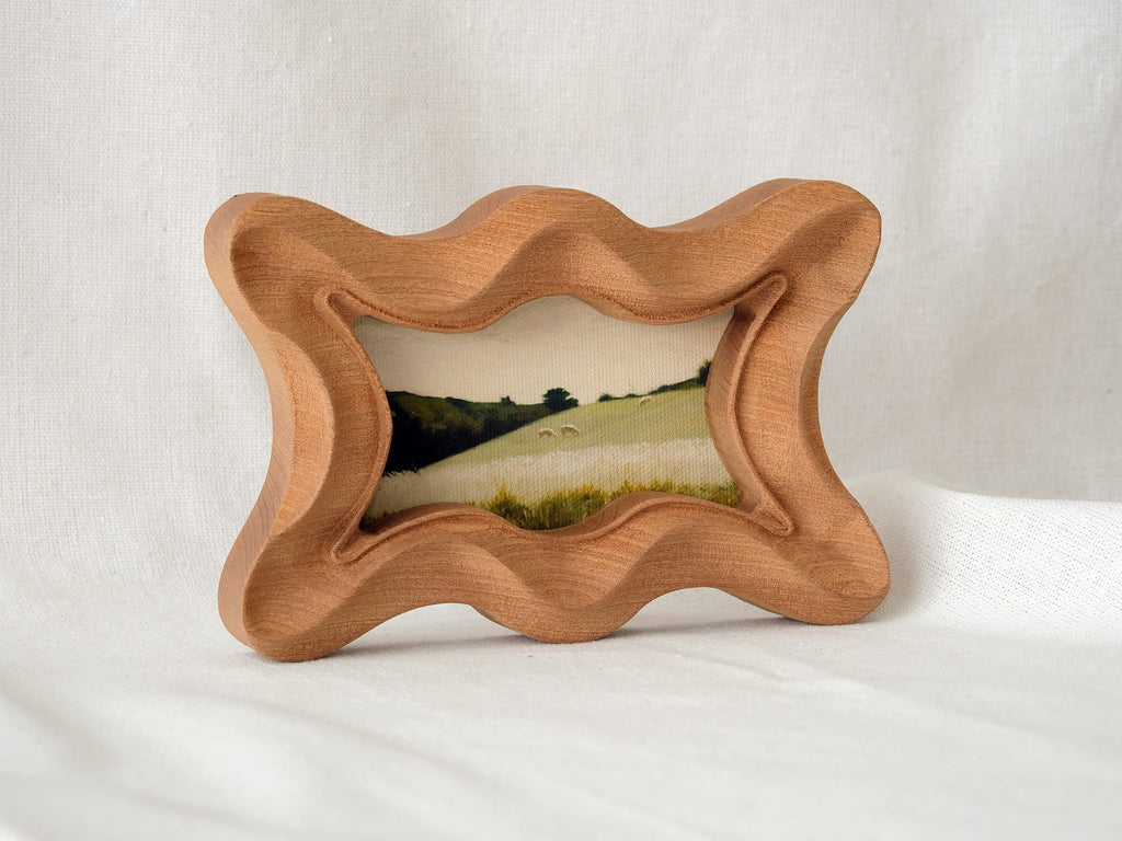 Standing view of the rippled wave wood frame, showcasing its dynamic undulating edges and stable artistic presence.