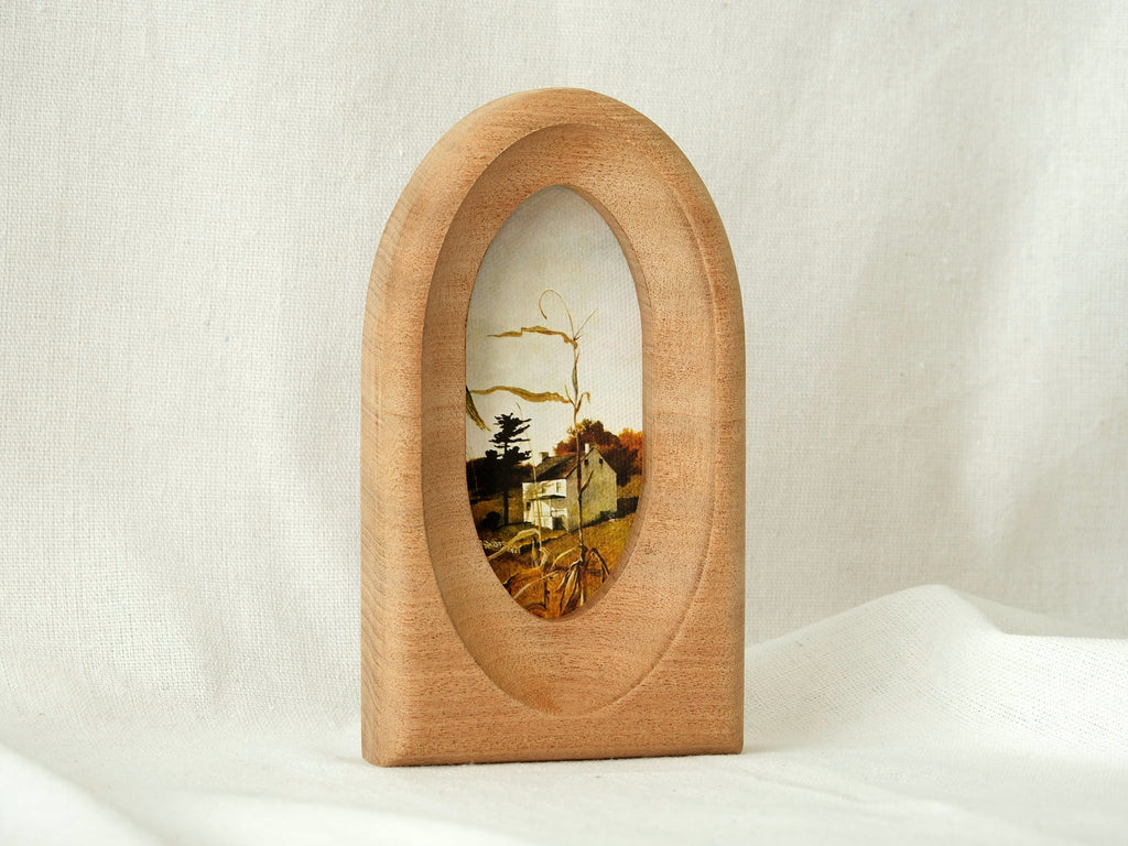 Standing view of the arched wood art frame, showing its elegant portal silhouette and stable architectural design.