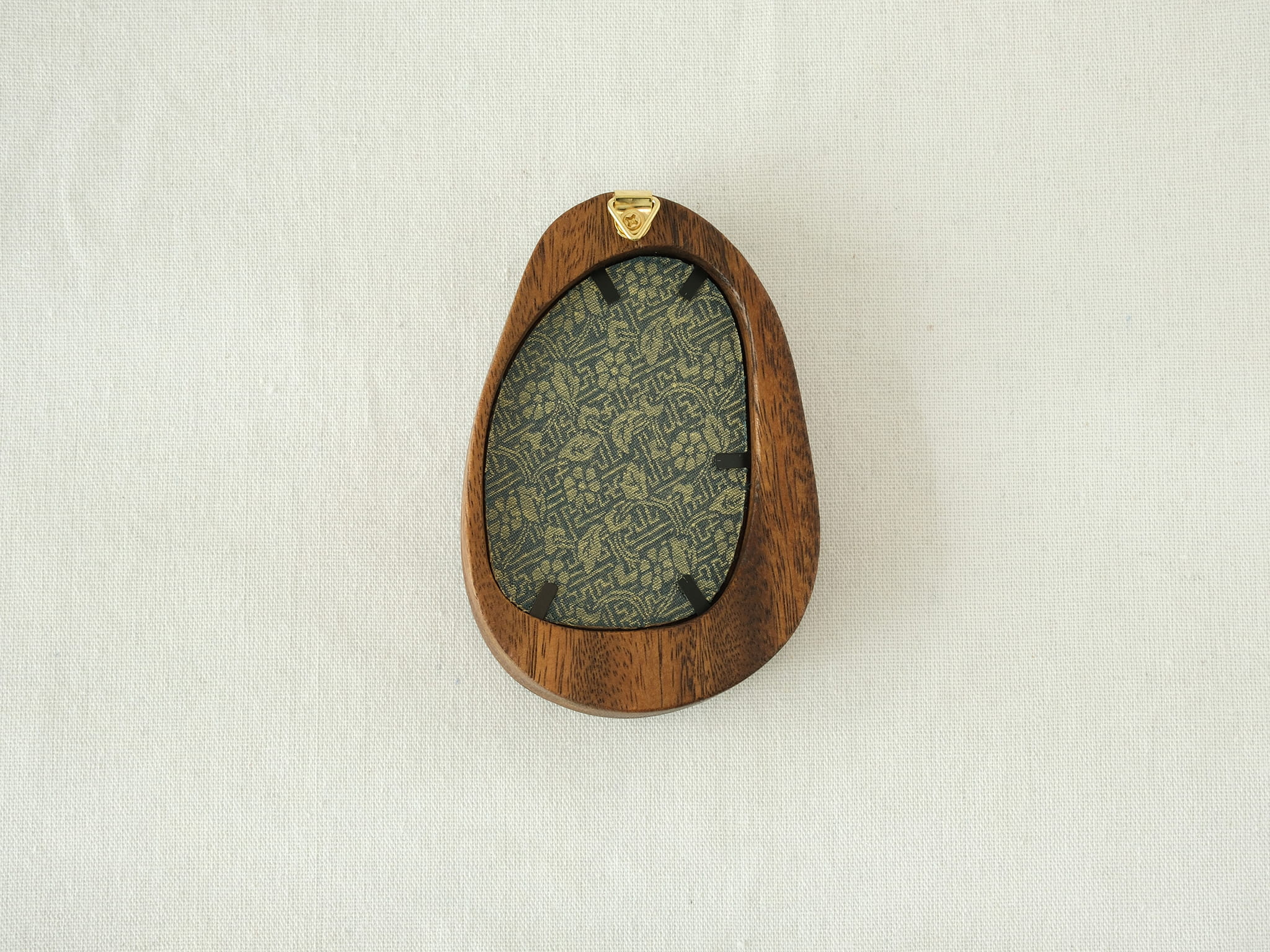Rear view of the Waterdrop solid wood frame, showcasing its organic pebble-like profile and the integrated gold hanger for easy wall mounting.