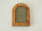 Rear view of the arched "Tuscany" solid wood frame, showing the integrated gold wall hanger and the elegant blue and gold floral textile backing that protects the artwork.