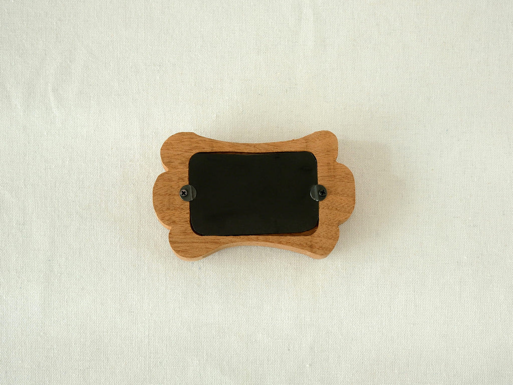 Back view of the bone-shaped frame, showing the clean wood finish and two swivel tabs for easy desktop photo display.
