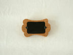 Back view of the bone-shaped frame, showing the clean wood finish and two swivel tabs for easy desktop photo display.