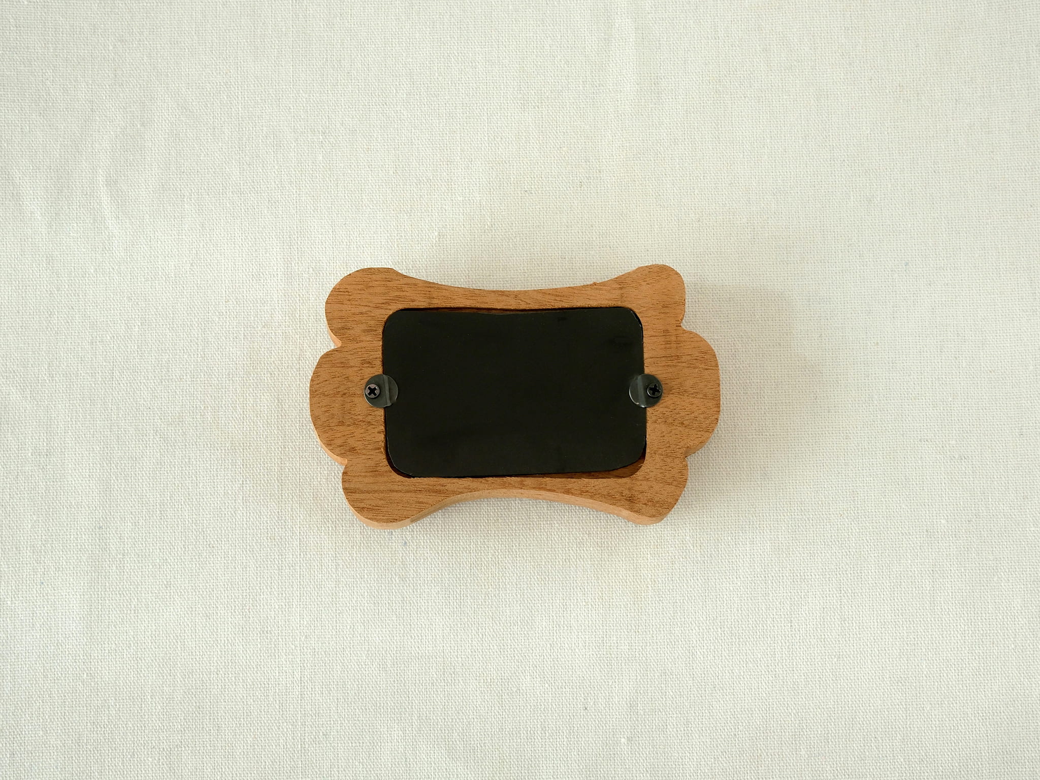 Back view of the bone-shaped frame, showing the clean wood finish and two swivel tabs for easy desktop photo display.