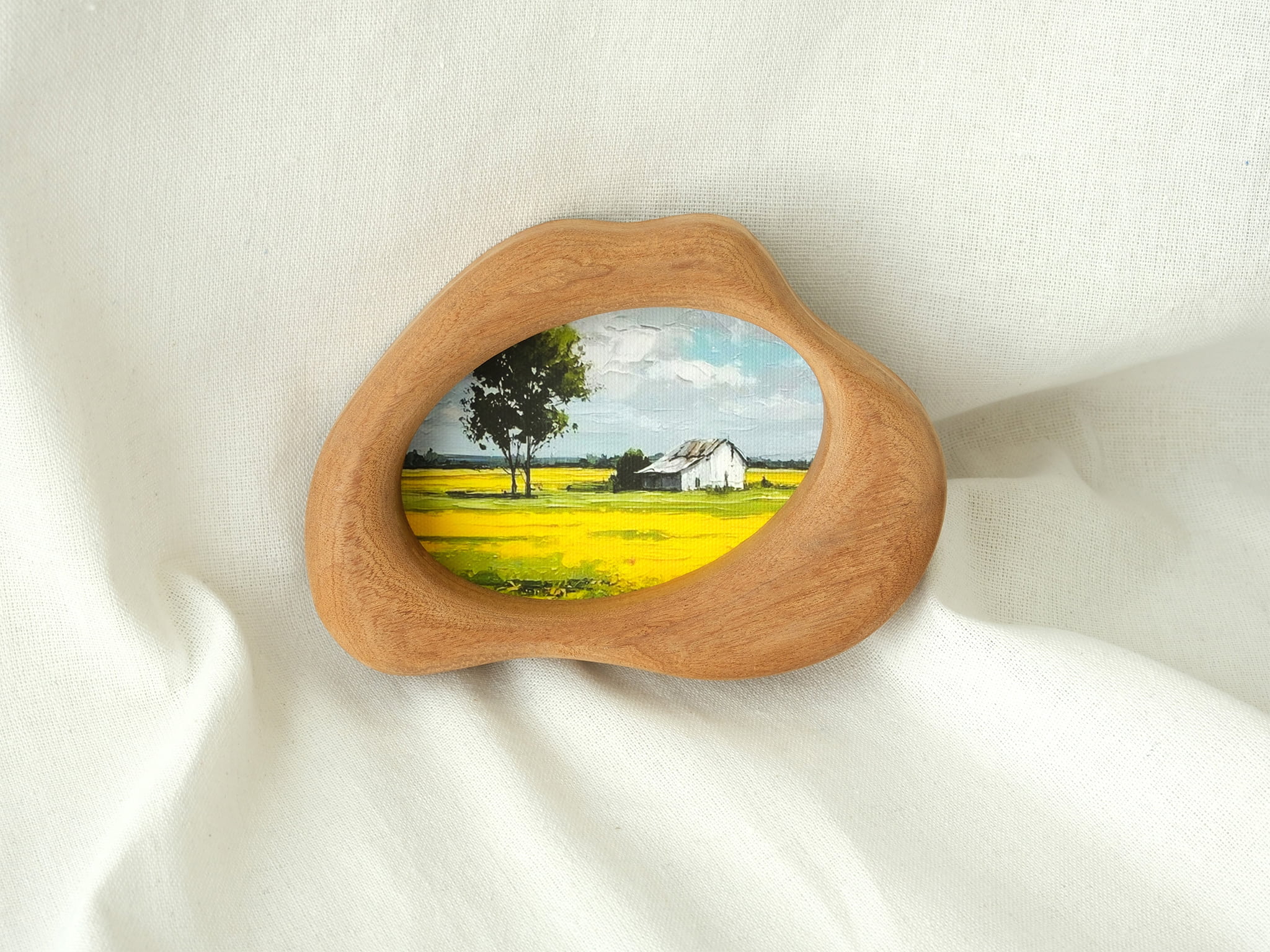 Cloud-shaped wood art frame leaning against a wall, showcasing its decorative, artistic presence in a home setting.