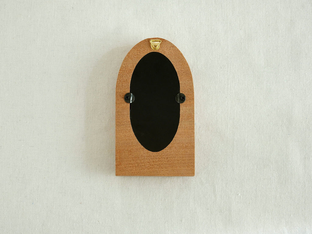 Back view of the arched wood frame, featuring a built-in metal hanger and secure turn-button hardware.