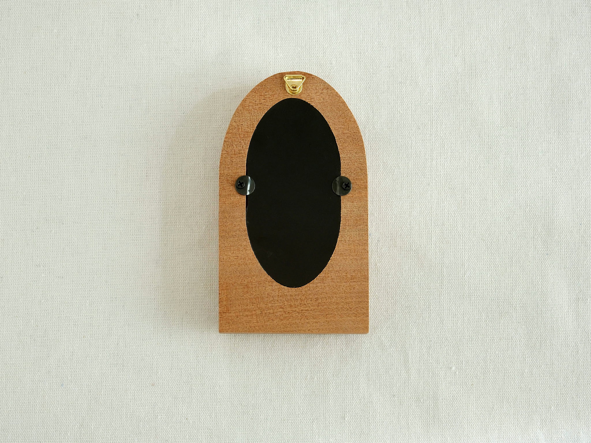 Back view of the arched wood frame, featuring a built-in metal hanger and secure turn-button hardware.