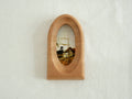 Front view of an elegant arched wood art frame, featuring a portal-like silhouette and smooth hand-sculpted finish.