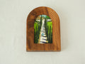 Front view of the arched solid wood frame "Tuscany," featuring a handcrafted stepped border and an oil-style painting of a cypress-lined road leading to an Italian villa.