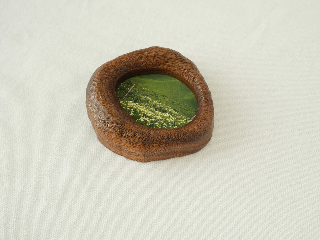 A close-up side view of the lake-shaped organic wood frame, showcasing the rustic hand-carved textures and the natural thickness of the solid timber.