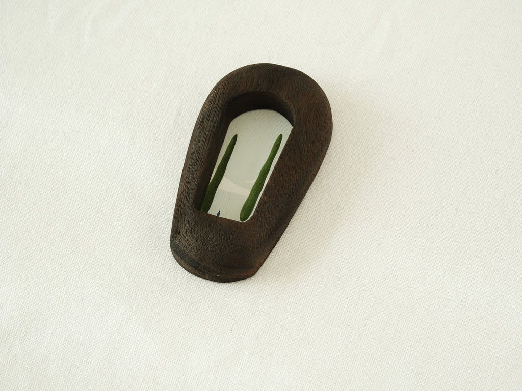 Angled side view of the black arched wood frame, revealing its smooth curved profile and elegant dark wood grain.