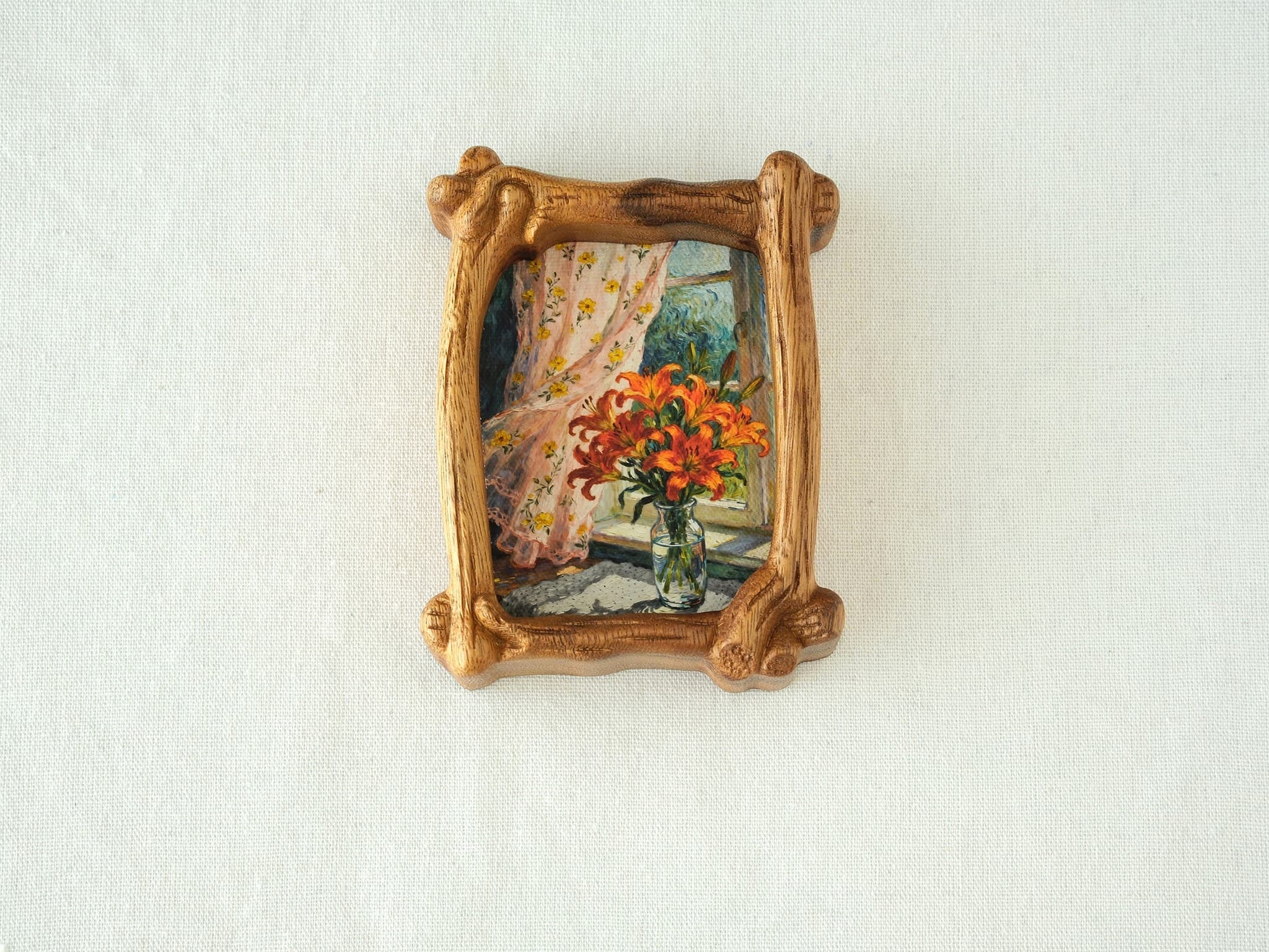 Front view of the handcrafted wood frame, showcasing its organic branch design and the floral art print, on a white canvas background.