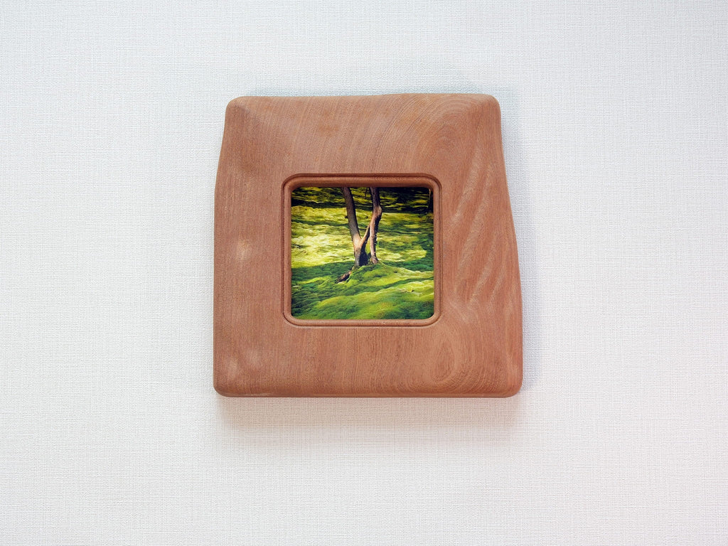 Large handmade solid wood picture frame with green forest artwork, front view.