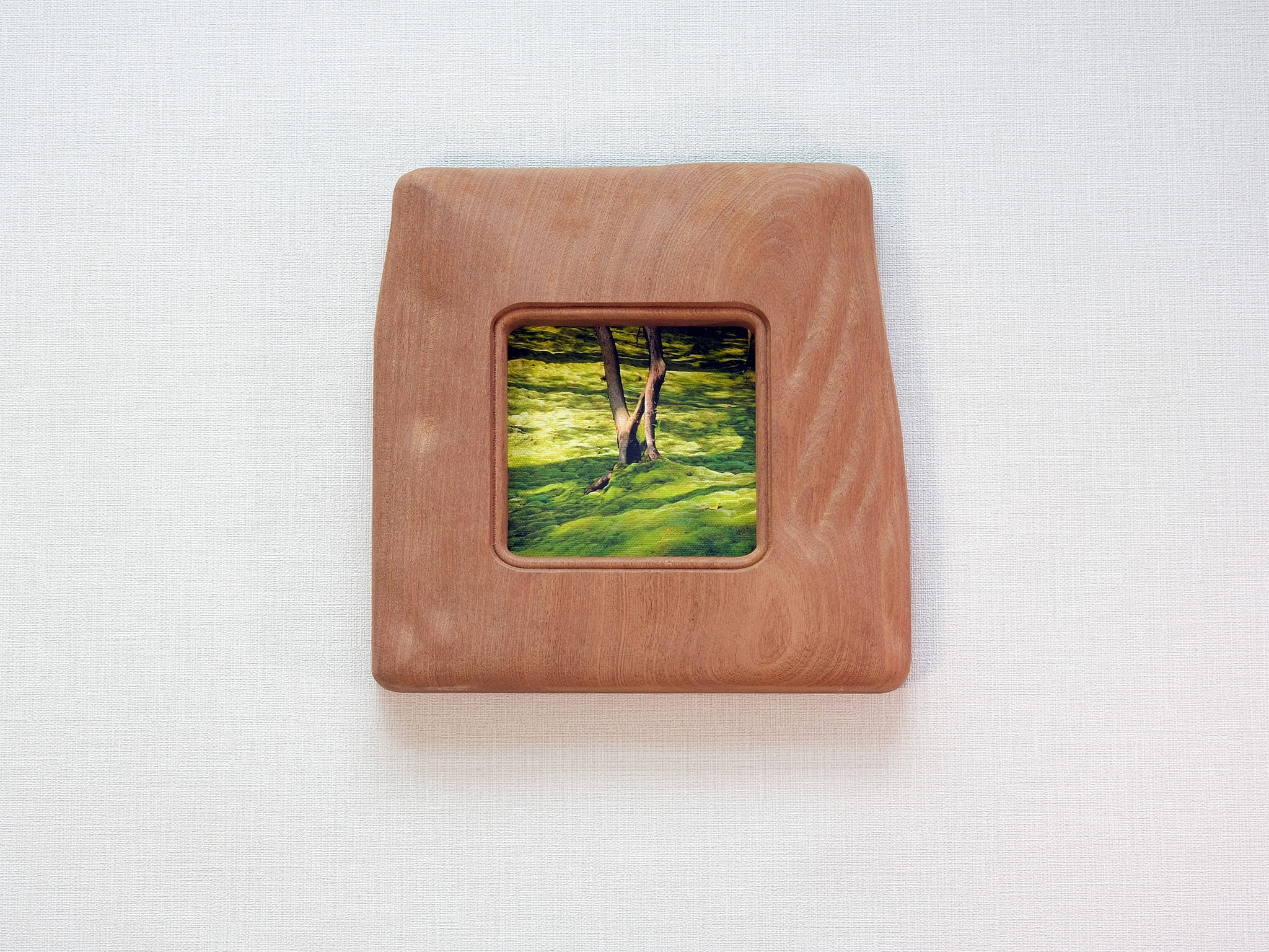 Large handmade solid wood picture frame with green forest artwork, front view.