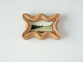 Front view of a rippled wave wood frame, featuring fluid organic edges and a hand-sculpted sculptural silhouette.