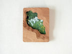 Large handmade solid wood wall art picture frame with flowing stream-shaped cutout and floral meadow artwork, front view.