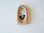 Front view of an elegant arched wood art frame, featuring a portal-like silhouette and smooth hand-sculpted finish.