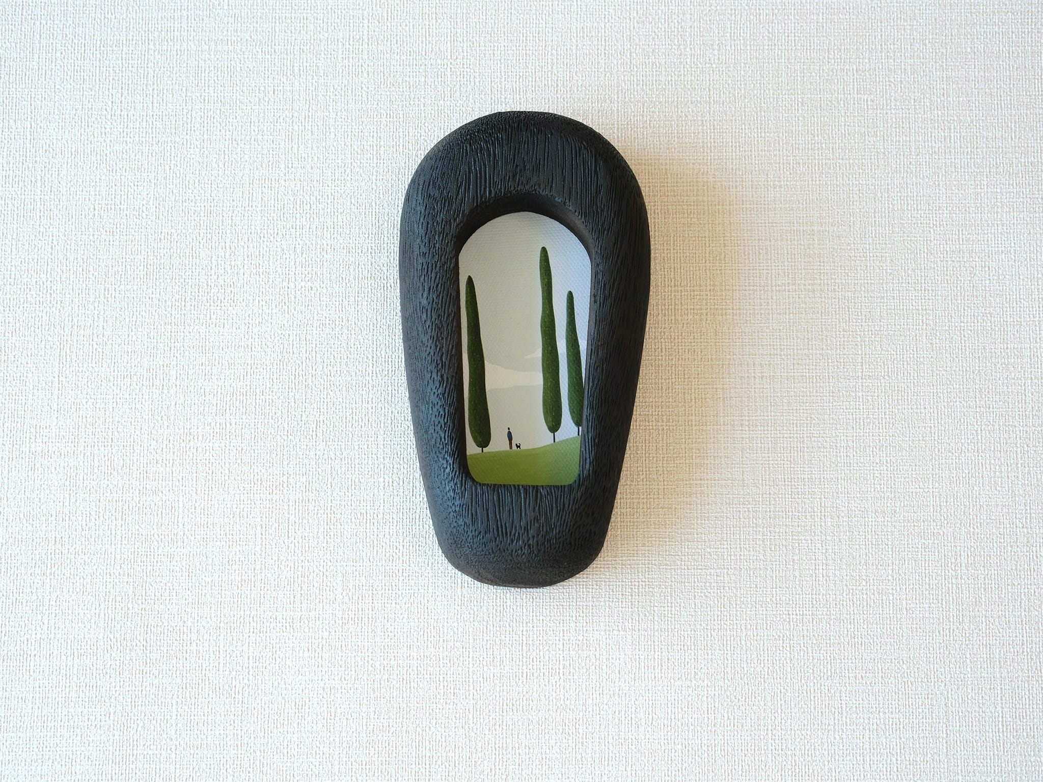 Front view of a slim black arched wood frame, featuring a minimalist silhouette and rich dark grain texture.
