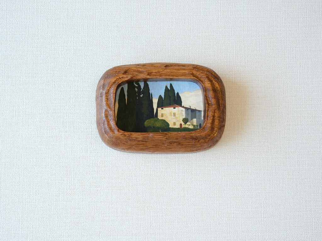 Handcrafted South American walnut wood picture frame with organic chunky shape and a landscape art print.