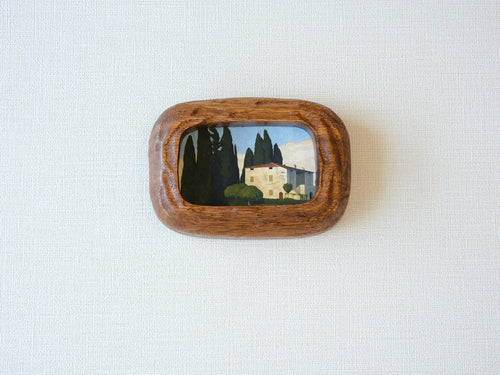 Handcrafted South American walnut wood picture frame with organic chunky shape and a landscape art print.
