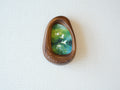 Front view of the Waterdrop handmade solid wood art frame featuring birds flying over a lush forest, highlighting the organic pebble shape and natural wood grain.