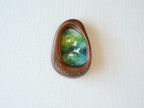 Front view of the Waterdrop handmade solid wood art frame featuring birds flying over a lush forest, highlighting the organic pebble shape and natural wood grain.