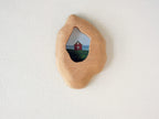 Handmade solid wood wall hanging art picture frame with red house artwork, organic shape front view.