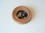 High-angled view of the round flower frame, showing its three-tier stepped design and detailed hand-carved textures.