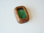 Angled top-down view of the rounded rectangle solid wood frame, showing the deep-set art chamber and the bold, natural grain of the thick timber walls.