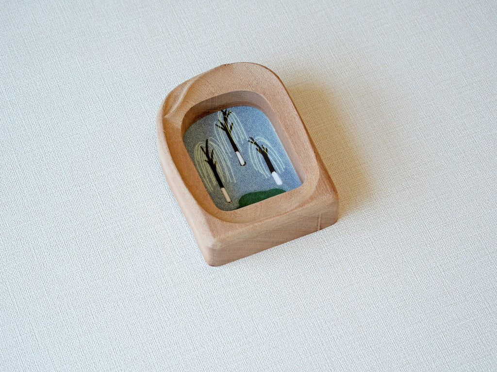 Side angle of the soft arched wood frame, emphasizing its smooth, hand-carved organic curves and warm grain.
