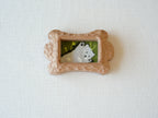 Front view of the bone-shaped wood pet frame, highlighting its symmetrical organic silhouette and detailed hand-chiselled surface.