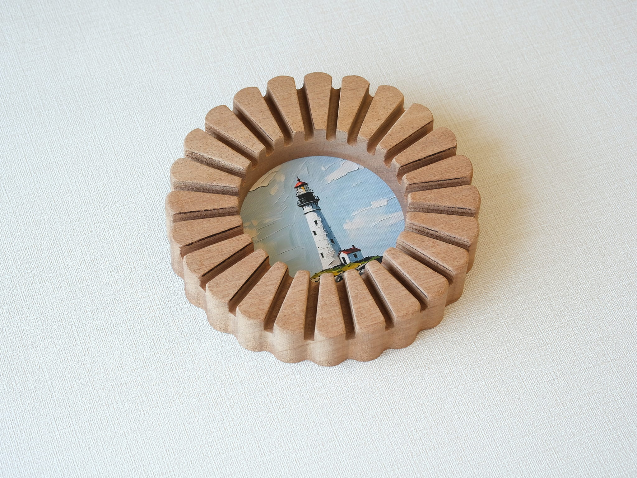 A high-angle view of the sunflower circular solid wood frame lying on a white textured surface, highlighting its natural wood grain.