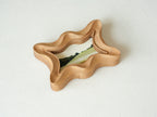 Angled top view of the rippled wave wood frame, highlighting its deep fluid ridges and intricate hand-sculpted texture.