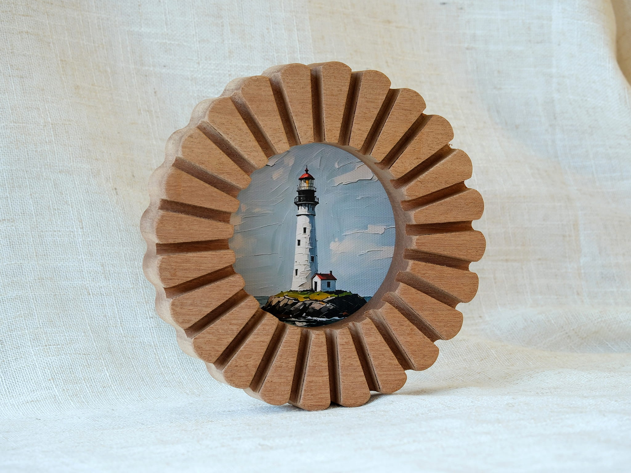The handcrafted sunflower circular solid wood frame standing on a white surface, showcasing its sunburst edge and lighthouse art.