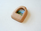 Side view of the house-shaped wood frame, highlighting its smooth, hand-carved organic edges and thick solid Sapele.