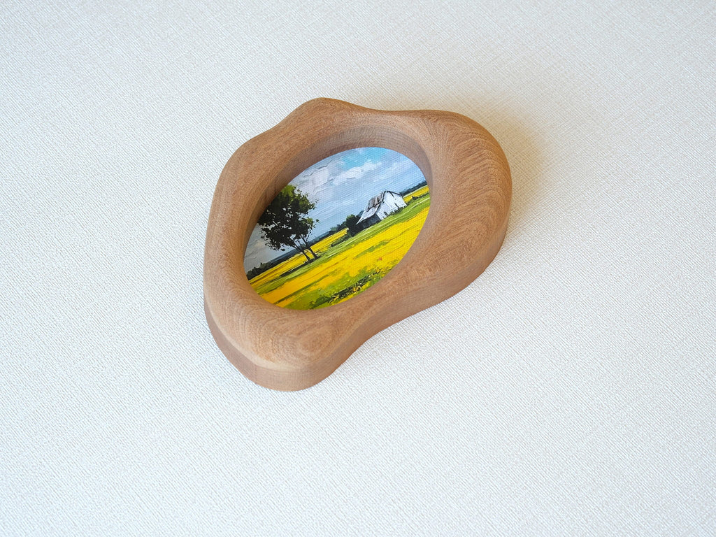 Side view of the cloud-shaped wood art frame, showing hand-sculpted organic curves and its sculptural depth.