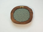 Large walnut wood picture frame back view with wall hanger and patterned backing panel.