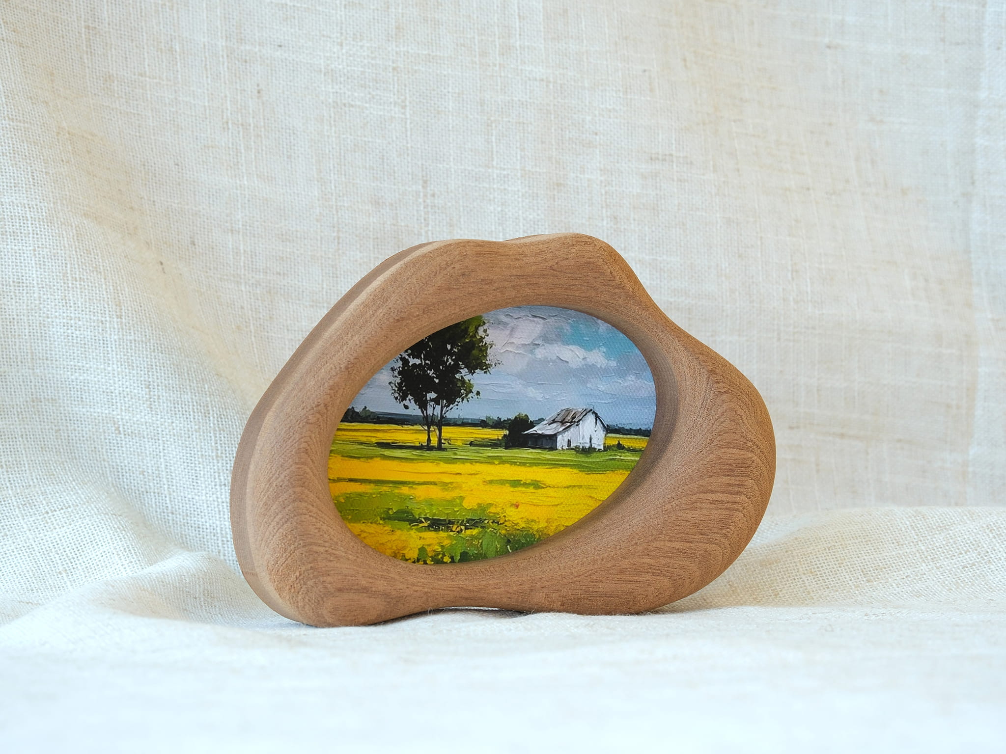 Standing view of the cloud-shaped wood art frame, demonstrating its stability and elegant organic silhouette.