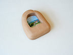 Alternative side angle of the house-shaped frame, showcasing the unique undulating texture and rich natural wood grain.