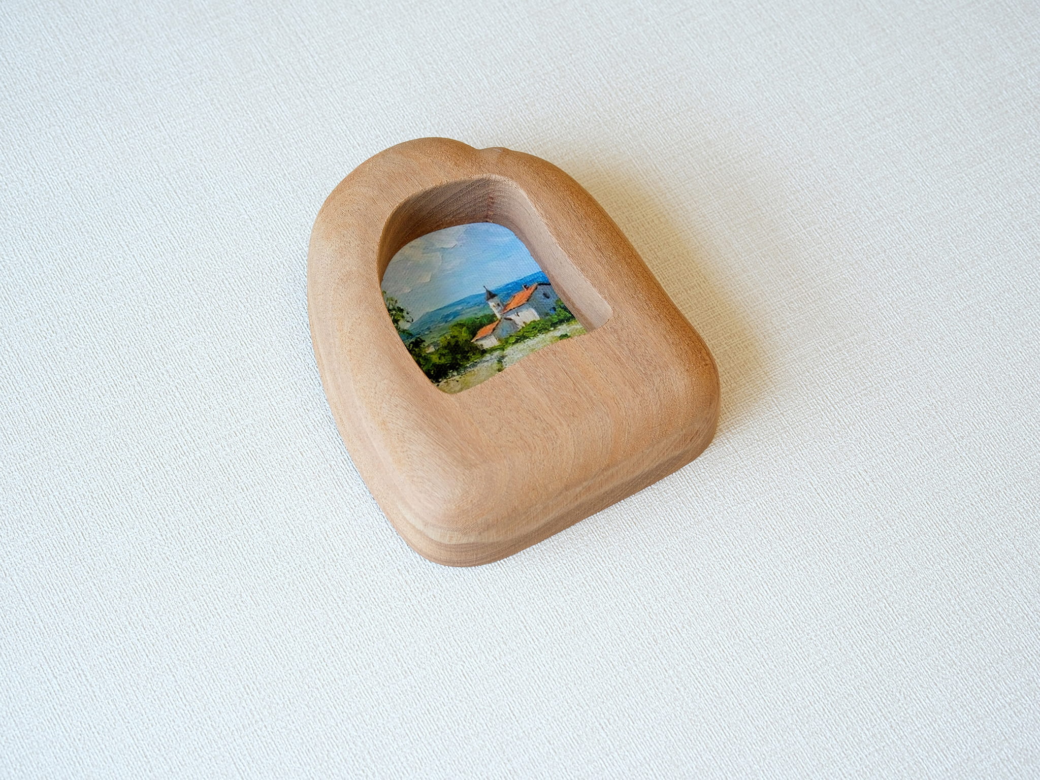 Alternative side angle of the house-shaped frame, showcasing the unique undulating texture and rich natural wood grain.