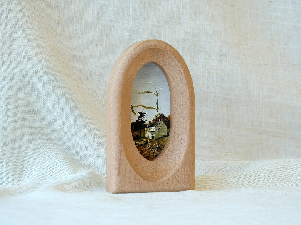 Standing view of the arched wood art frame, showing its elegant portal silhouette and stable architectural design.
