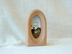 Standing view of the arched wood art frame, showing its elegant portal silhouette and stable architectural design.