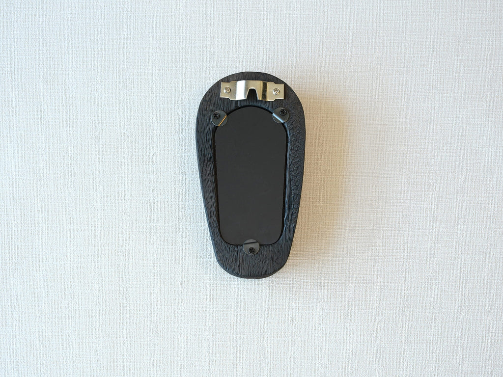 Back view of the black arched frame, featuring an integrated metal wall hanger and three secure swivel tabs.