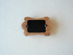 Back view of the bone-shaped frame, showing the clean wood finish and two swivel tabs for easy desktop photo display.