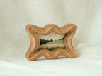 Standing view of the rippled wave wood frame, showcasing its dynamic undulating edges and stable artistic presence.
