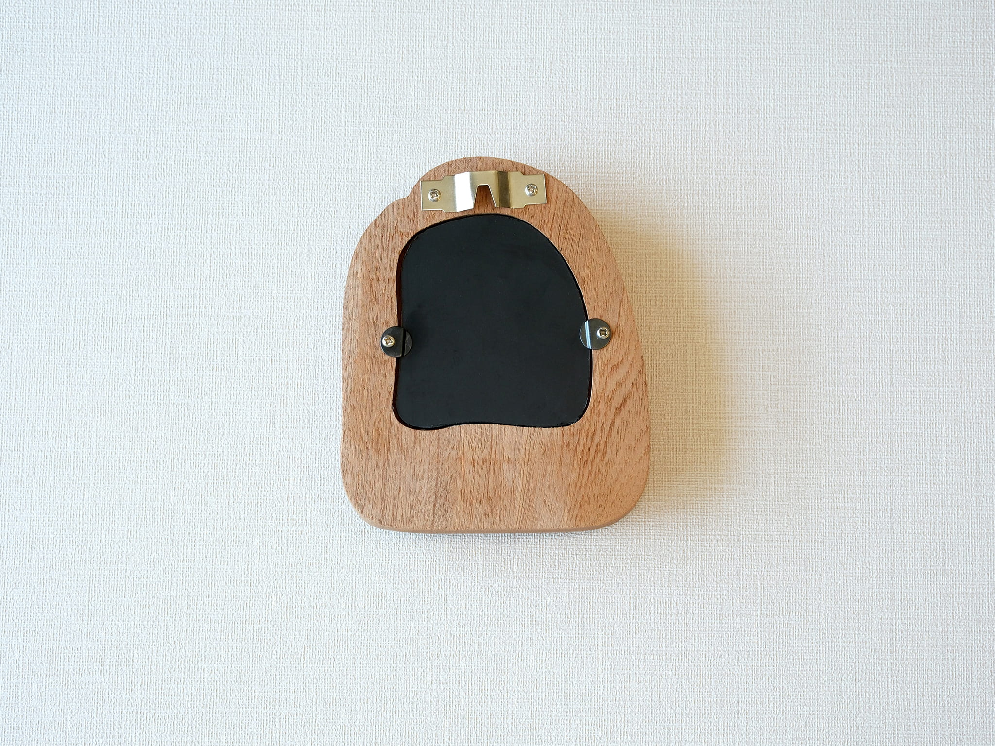 Back view of the house-shaped frame, featuring a sturdy sawtooth wall hanger and secure swivel tabs for artwork.