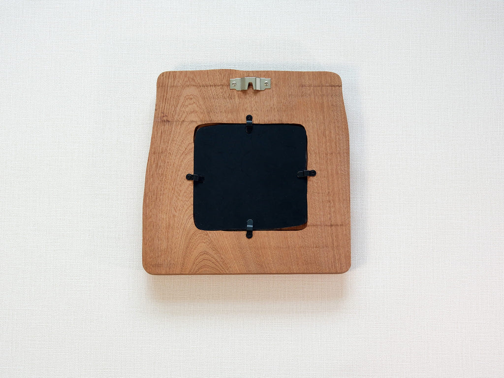 Back view of large handmade solid wood picture frame with wall hanger and removable black backing panel.